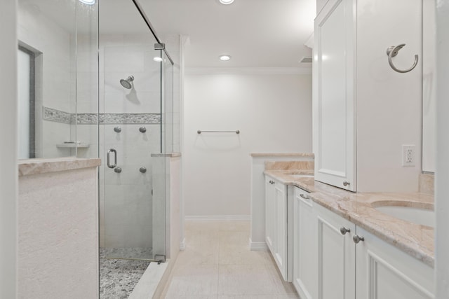 bathroom featuring tile patterned flooring, vanity, ornamental molding, and walk in shower