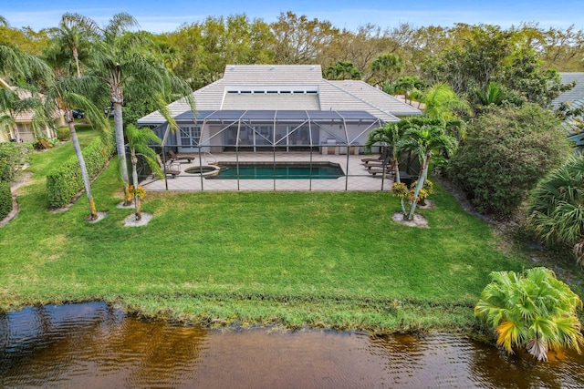 back of house featuring a patio, a water view, glass enclosure, and a lawn