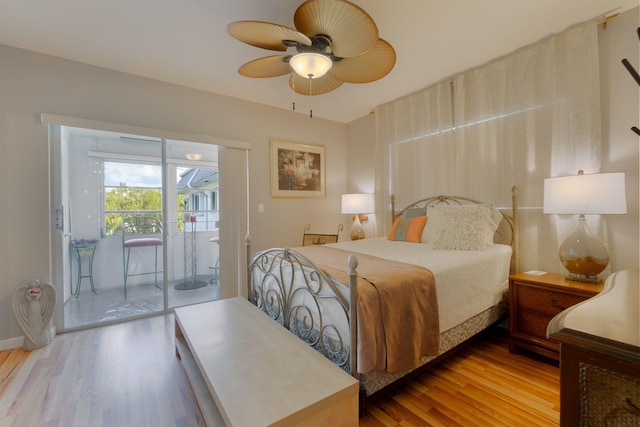 bedroom with access to exterior, wood-type flooring, and ceiling fan