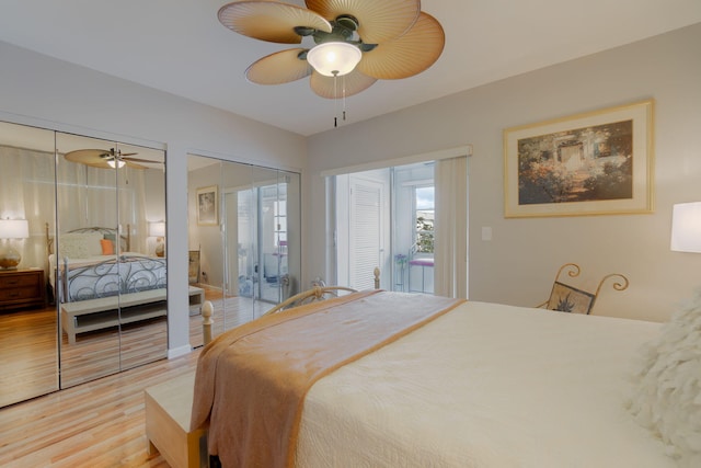 bedroom featuring access to exterior, light hardwood / wood-style flooring, ceiling fan, and multiple closets