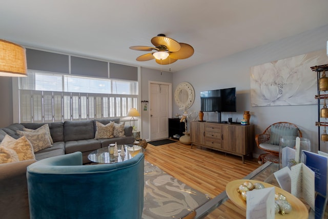 living room featuring hardwood / wood-style floors and ceiling fan