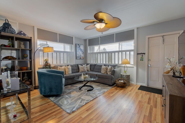 living room with ceiling fan and light hardwood / wood-style flooring