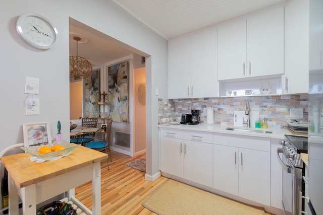 kitchen with tasteful backsplash, sink, light hardwood / wood-style flooring, white cabinets, and stainless steel electric range oven