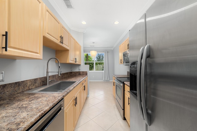 kitchen with sink, hanging light fixtures, stainless steel appliances, light tile patterned floors, and ornamental molding