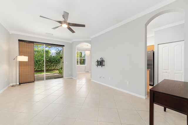 tiled spare room with ceiling fan and crown molding