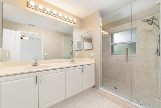 bathroom with ceiling fan, a shower with shower door, and vanity