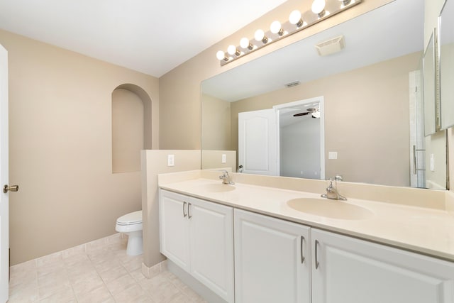 bathroom with vanity, tile patterned floors, ceiling fan, toilet, and a shower with shower door