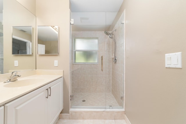 bathroom with tile patterned flooring, vanity, and an enclosed shower