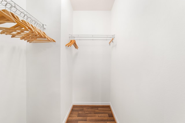 walk in closet featuring dark wood-type flooring