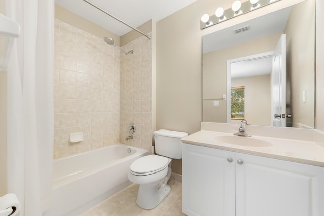 full bathroom featuring tile patterned floors, vanity, tiled shower / bath combo, and toilet