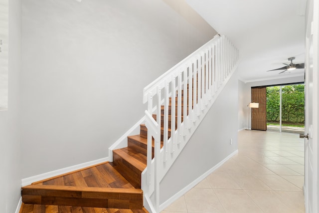 stairs with tile patterned floors and ceiling fan