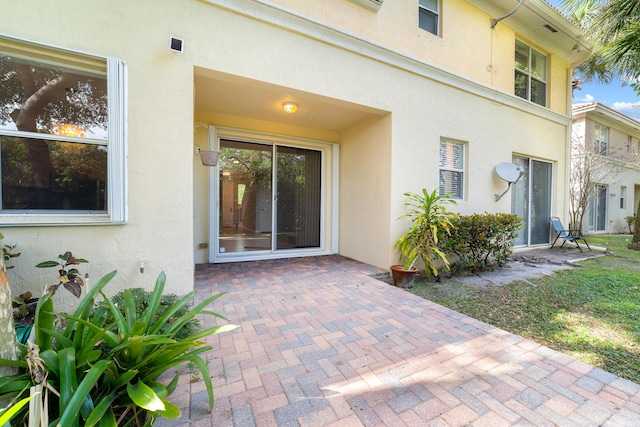 property entrance featuring a patio