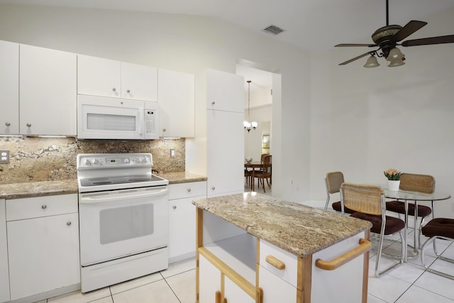 kitchen featuring white appliances, white cabinetry, vaulted ceiling, and backsplash