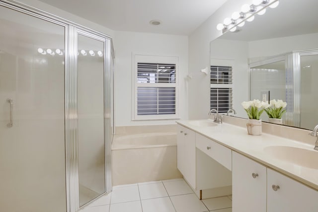 bathroom with tile patterned flooring, vanity, and plus walk in shower