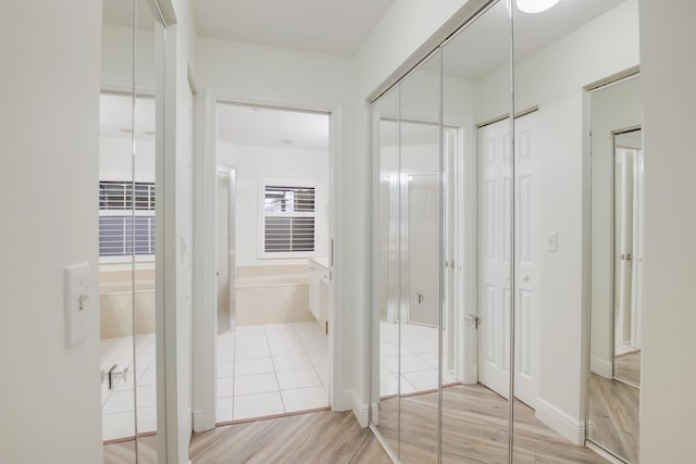 bathroom with a washtub and wood finished floors