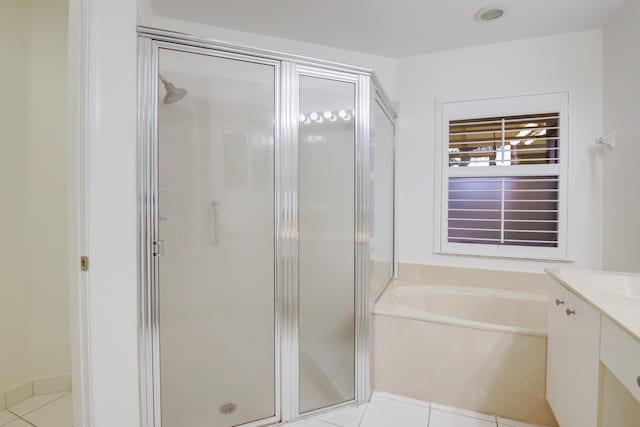 bathroom with tile patterned flooring, vanity, and plus walk in shower