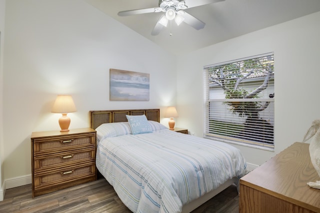 bedroom featuring ceiling fan, dark wood-type flooring, and lofted ceiling