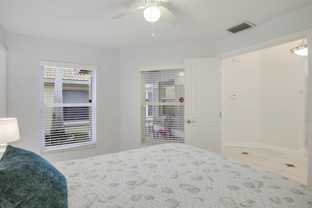 tiled bedroom featuring a ceiling fan, visible vents, and baseboards