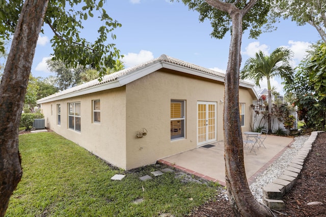 back of house with a patio area, central AC, a yard, and french doors