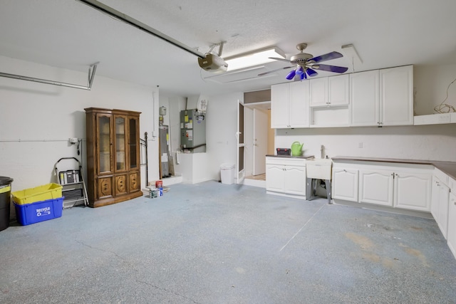 garage with heating unit, ceiling fan, sink, water heater, and a garage door opener