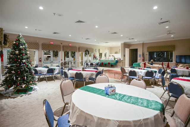 dining area featuring light carpet and ornamental molding