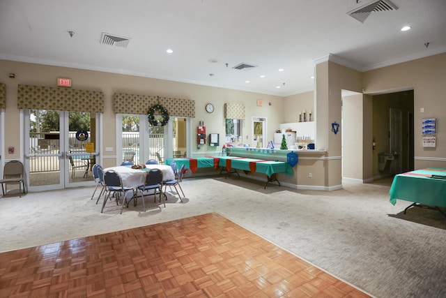 rec room with light colored carpet, crown molding, and french doors