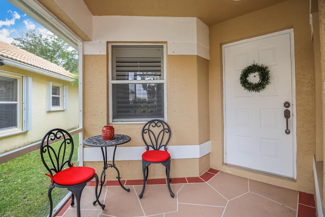 property entrance featuring stucco siding