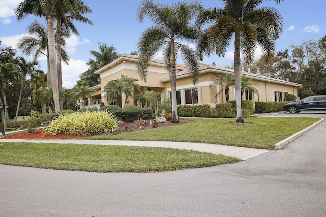 mediterranean / spanish home with a front yard