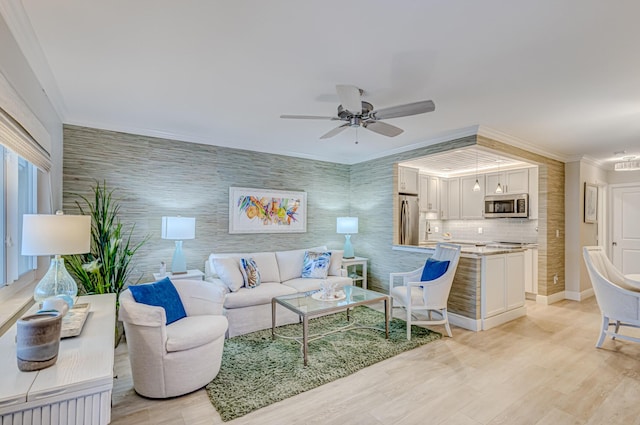 living room featuring light hardwood / wood-style floors, ceiling fan, and ornamental molding