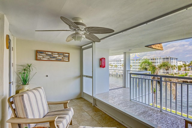 interior space with ceiling fan and a water view