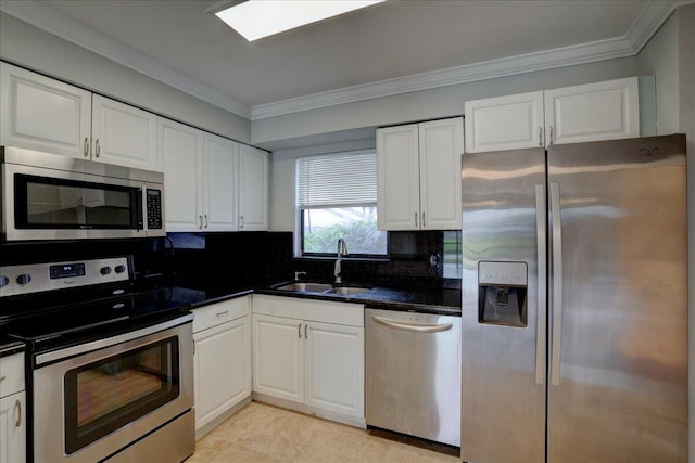 kitchen with sink, ornamental molding, tasteful backsplash, white cabinetry, and stainless steel appliances