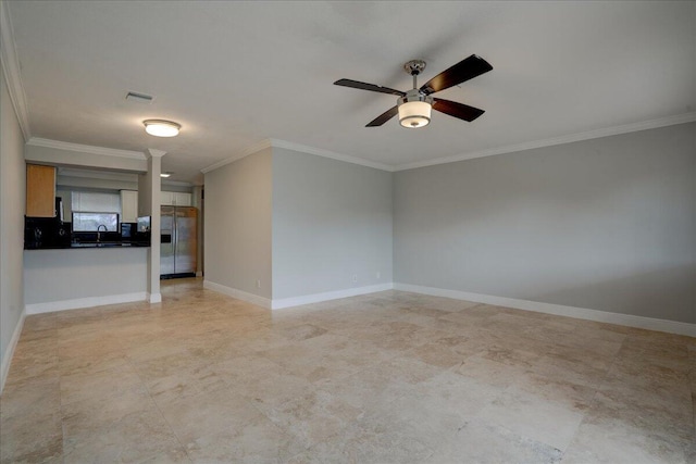 empty room featuring ceiling fan, sink, and ornamental molding