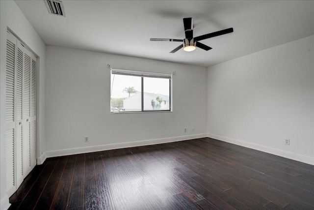 unfurnished bedroom featuring a closet, ceiling fan, and dark wood-type flooring