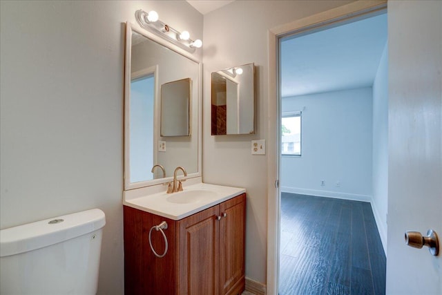 bathroom featuring hardwood / wood-style floors, vanity, and toilet