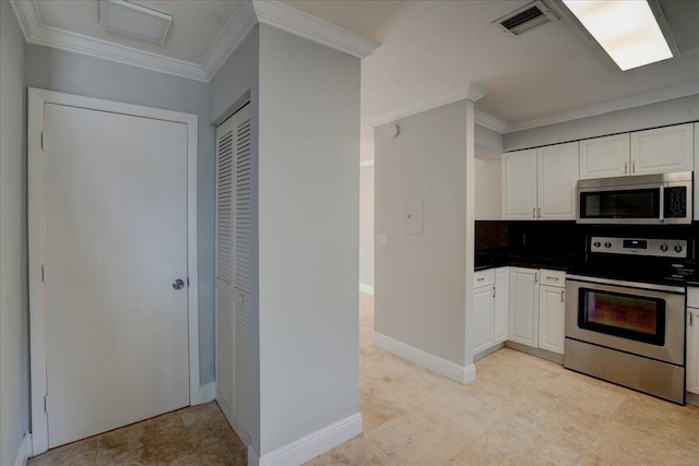 kitchen with white cabinetry, crown molding, appliances with stainless steel finishes, and tasteful backsplash