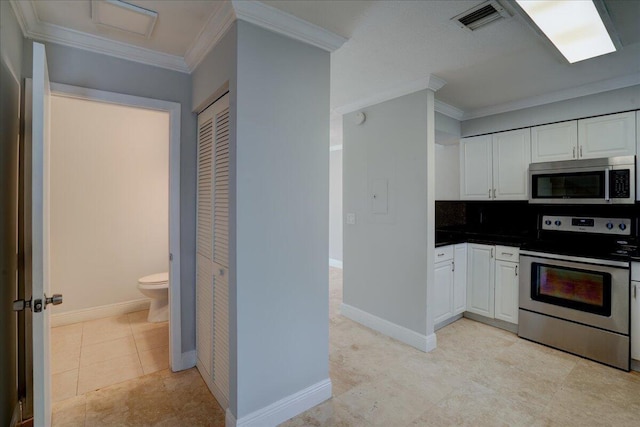 kitchen featuring appliances with stainless steel finishes, backsplash, ornamental molding, light tile patterned floors, and white cabinetry