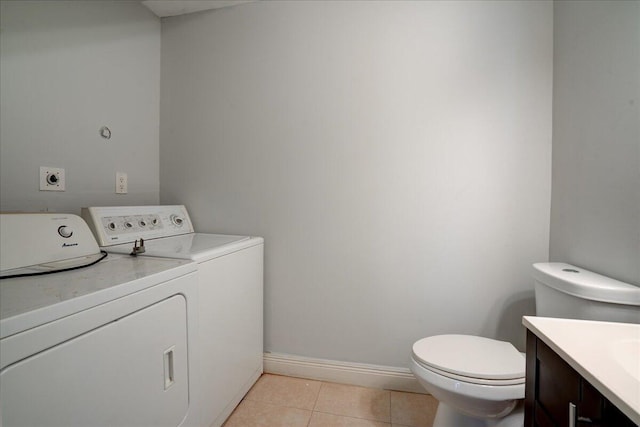 washroom featuring light tile patterned floors and washer and clothes dryer