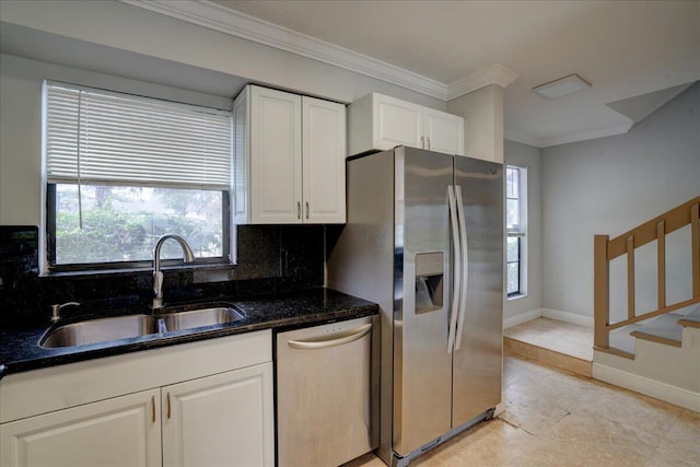 kitchen with appliances with stainless steel finishes, backsplash, dark stone counters, sink, and white cabinetry