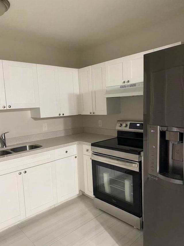 kitchen featuring white cabinetry, electric range, and refrigerator with ice dispenser