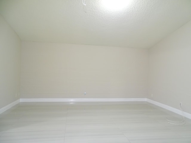 empty room featuring a textured ceiling