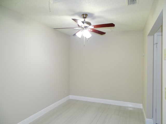 spare room with ceiling fan and a textured ceiling