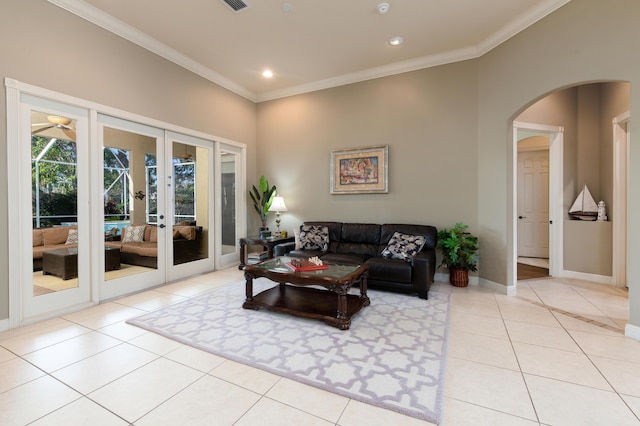 living room with french doors, light tile patterned floors, and ornamental molding