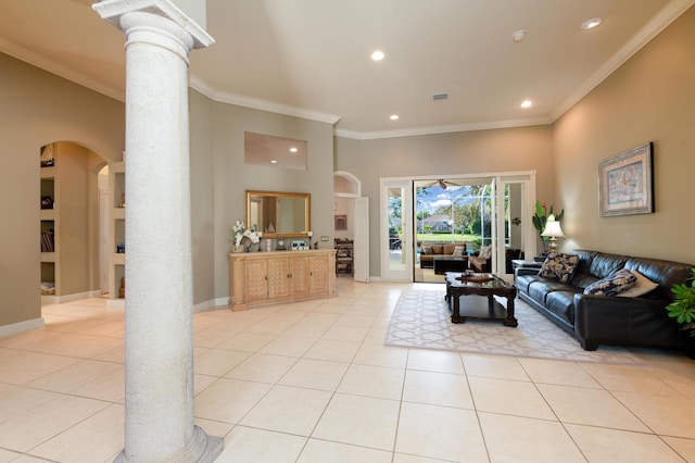 living room featuring light tile patterned floors, crown molding, and decorative columns