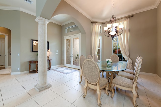 dining space with crown molding, arched walkways, a chandelier, french doors, and visible vents