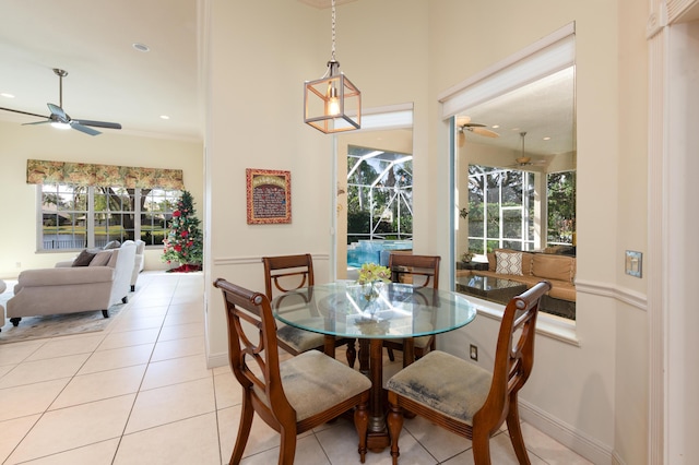 dining space featuring ceiling fan and light tile patterned floors