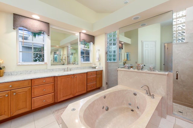 bathroom with tile patterned flooring, vanity, and separate shower and tub