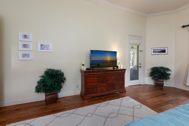 bedroom featuring ornamental molding and dark hardwood / wood-style flooring