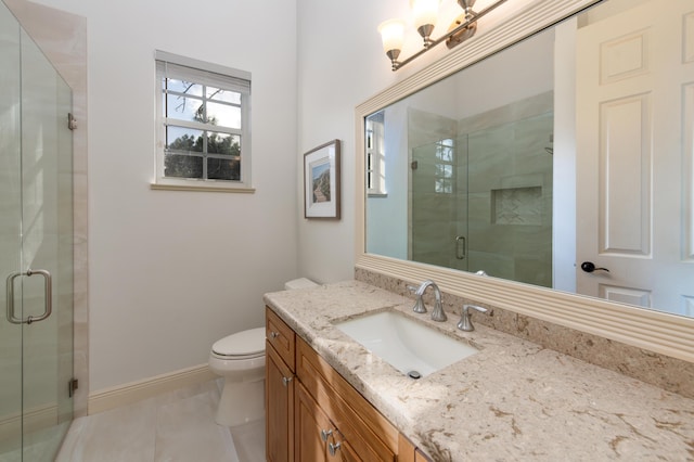 bathroom featuring tile patterned floors, vanity, toilet, and an enclosed shower