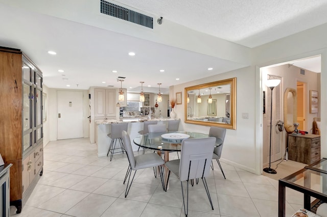 dining area with light tile patterned floors and a textured ceiling