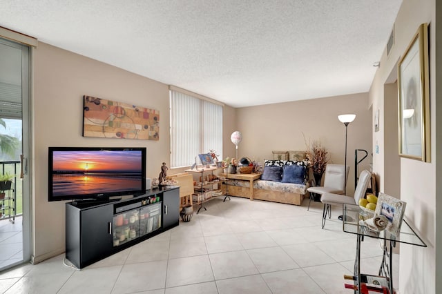 living room with light tile patterned floors and a textured ceiling